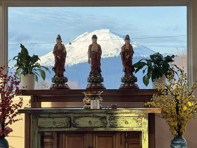 The view of Mt. Adams, snow-capped Mt. Adams, one of Washington state’s most iconic peaks, behind the Amitabha Trinity statues