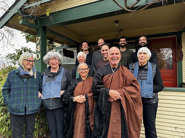 Sangha in front of the old farmhouse which is the current zendo, with resident teachers Kigetsu Ramana Waymire and Tendo Stacy Waymire