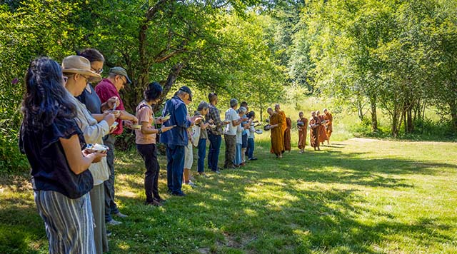 Monastics received alms at the Clear Mountain land in June, 2026, shortly after the land was purchased
