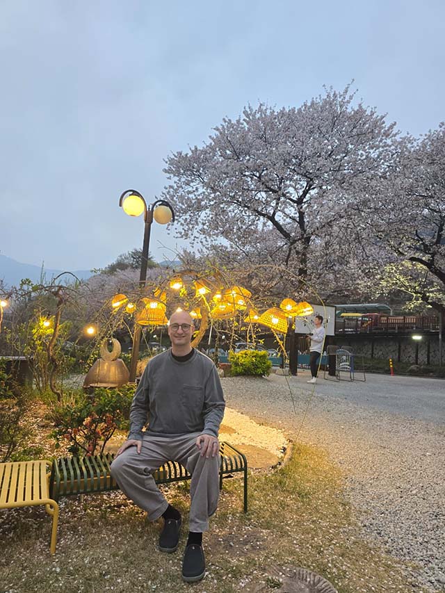 Jason Bartlett sitting in the village below the vihara