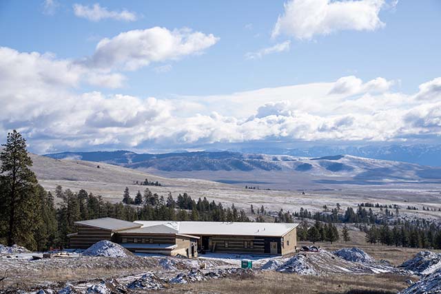 The three-year retreat buildings with a view of the Mission Mountains
